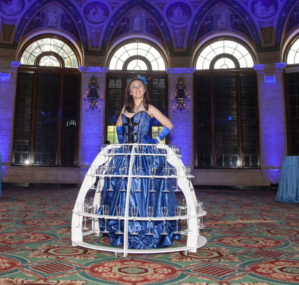 Champagne strolling table entertainer wearing an elegant themed costume