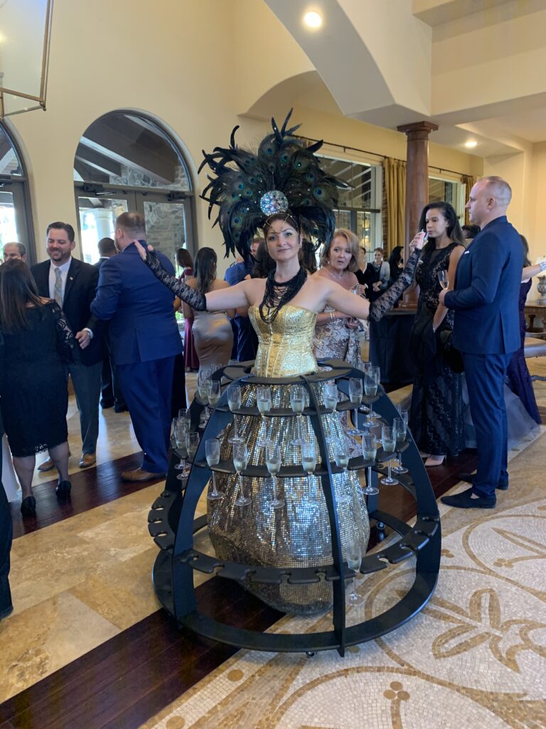 Champagne lady dress with champagne glasses at a luxury South Florida wedding