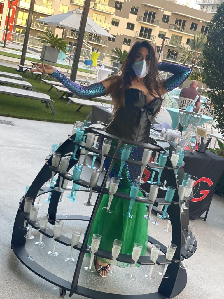 Elegant champagne lady greeting guests at a luxury Orlando event