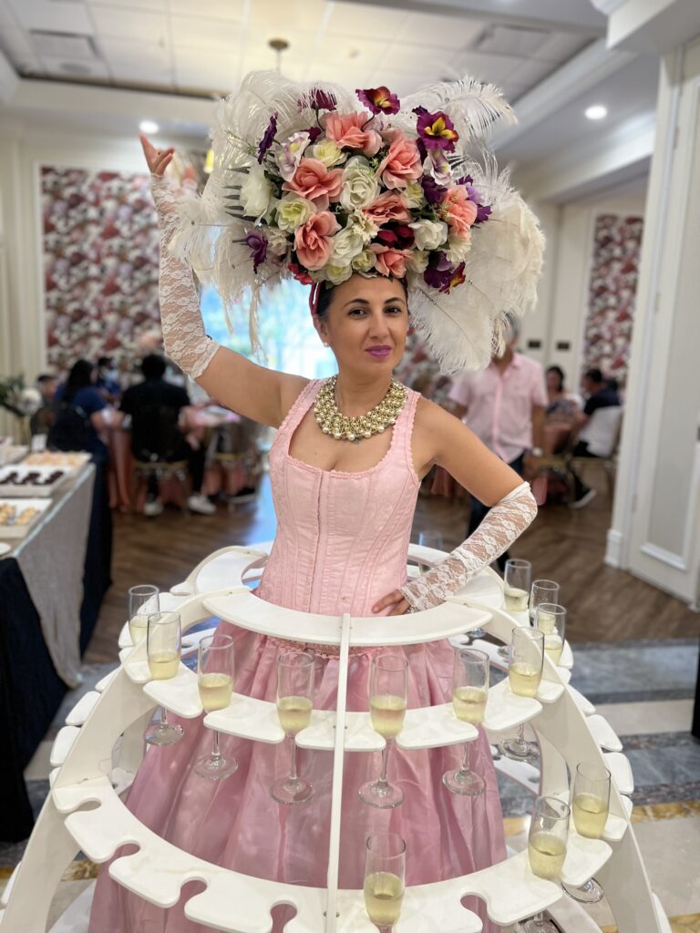 Champagne strolling table entertainer wearing an elegant themed costume