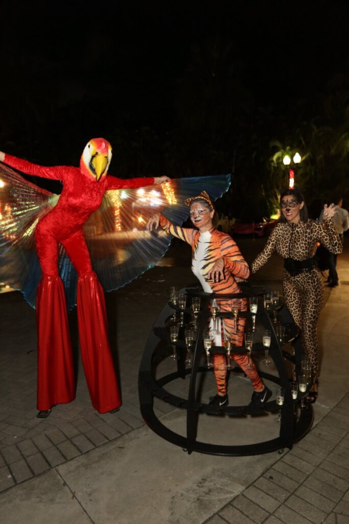 1. Strolling Tables Miami event entertainment featuring champagne ladies, LED robots, and photo booths