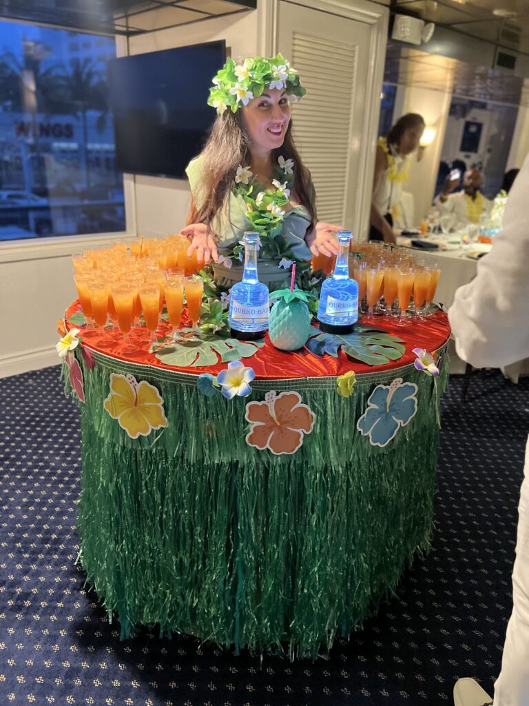 Unique champagne strolling table dress with decorative lighting at a private event